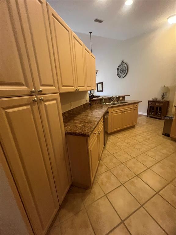 5373 Compass Point, Unit 1 Oxford, FL 34484 - Photo 9 of 38 a kitchen with stainless steel appliances granite countertop a sink and cabinets