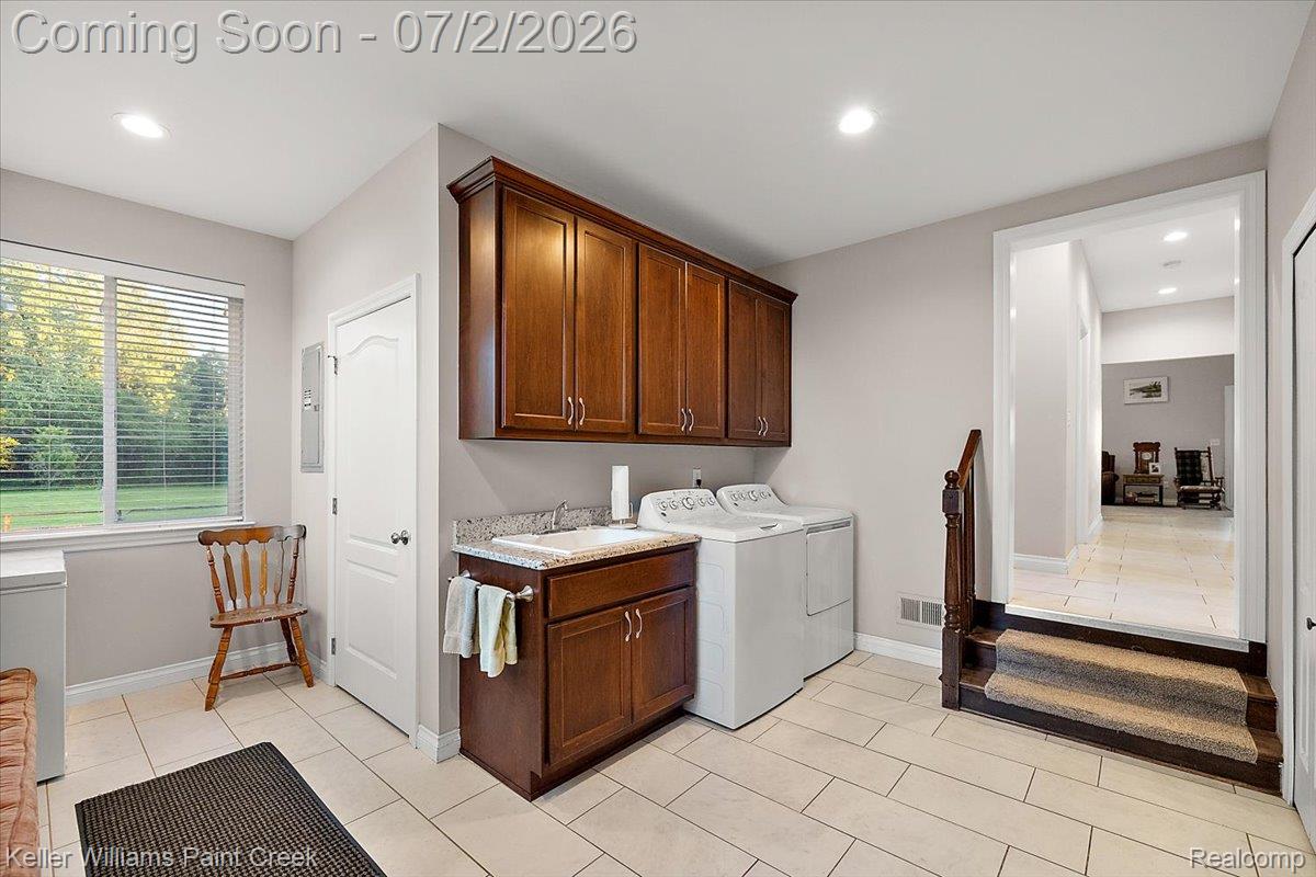 54230 Card Road Macomb, MI 48042 - Photo 41 of 73 Dedicated laundry area featuring wood cabinetry, stone-finish countertops, and a utility sink