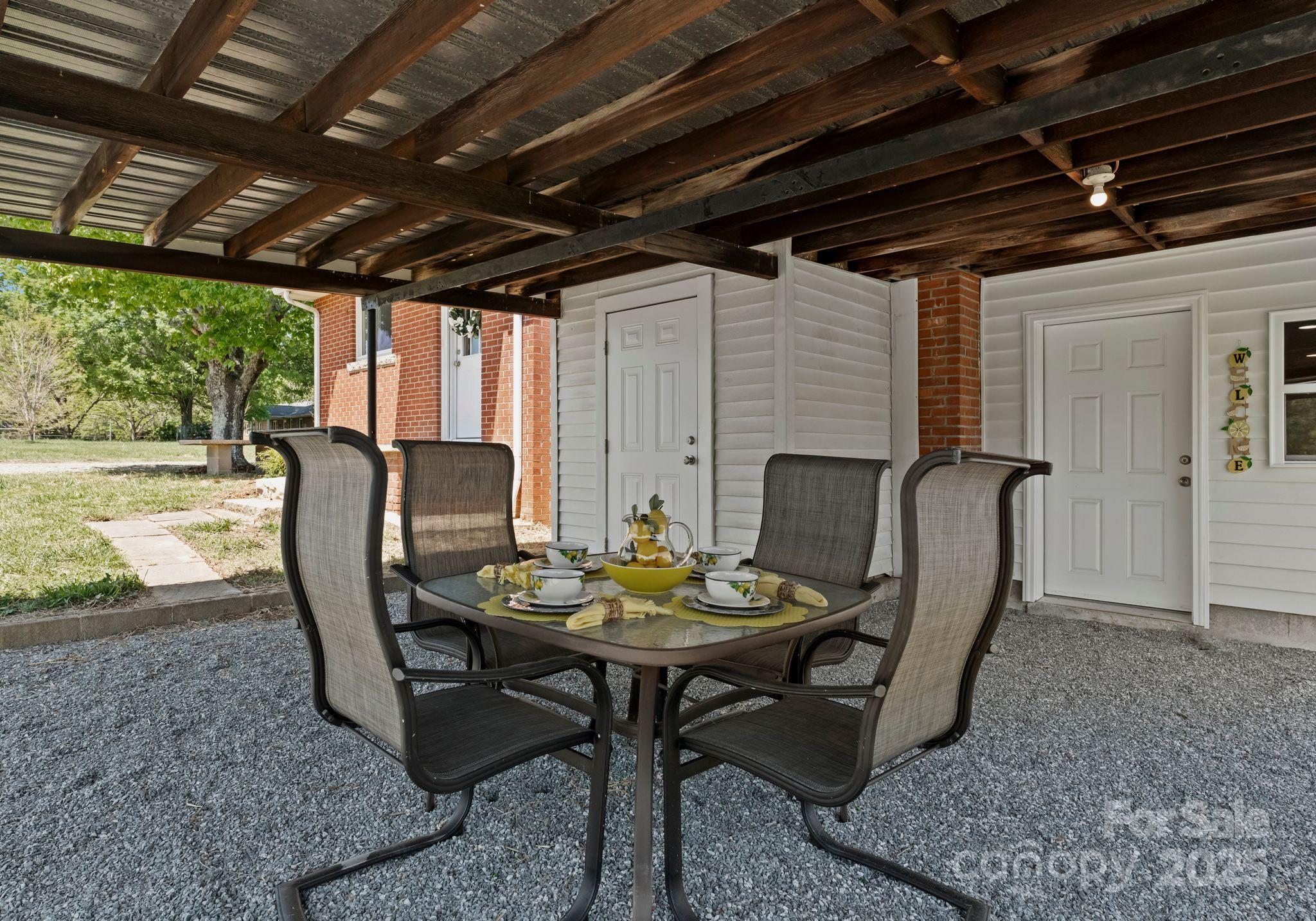 155 Jackson Road Salisbury, NC 28146 - Photo 21 of 26 a dining room with furniture a rug and a chandelier