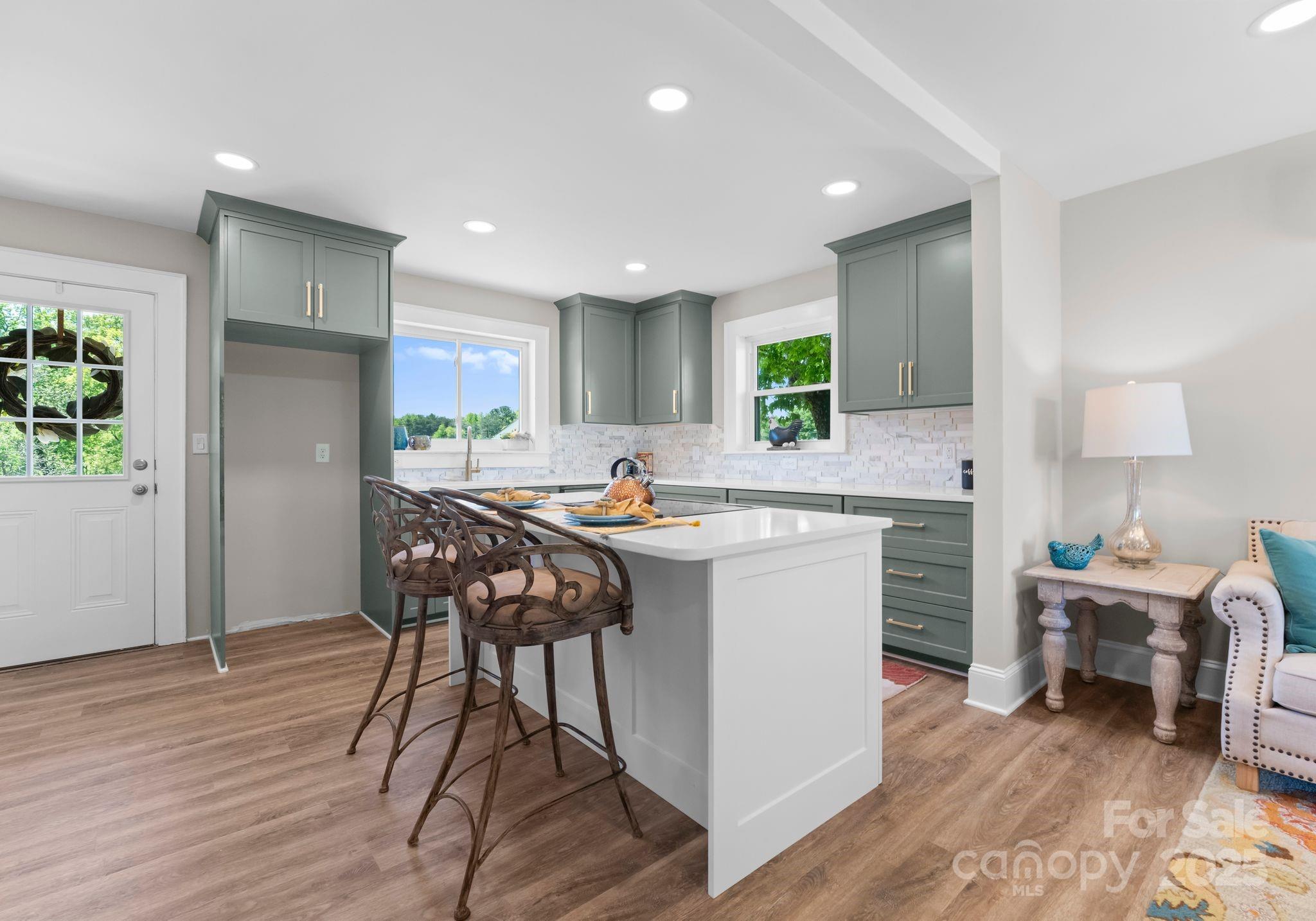 155 Jackson Road Salisbury, NC 28146 - Photo 6 of 26 a kitchen with a table chairs wooden floors and a view of living room