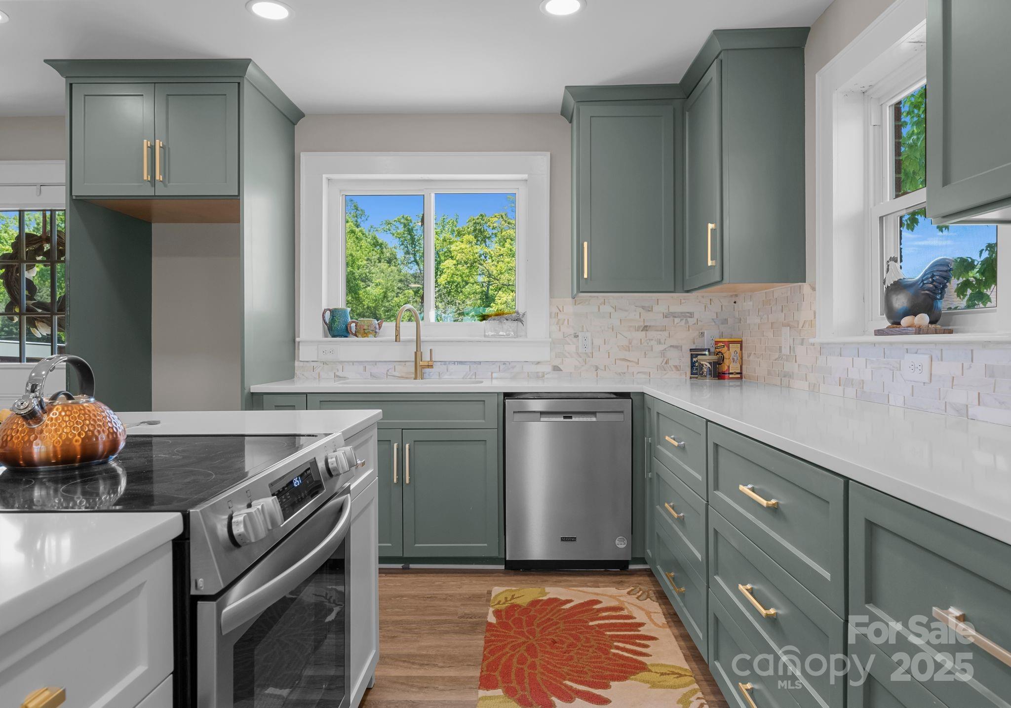 155 Jackson Road Salisbury, NC 28146 - Photo 8 of 26 a kitchen with a sink a stove cabinets and a window