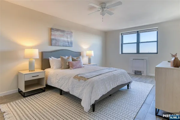 a bedroom with bed and a night stand