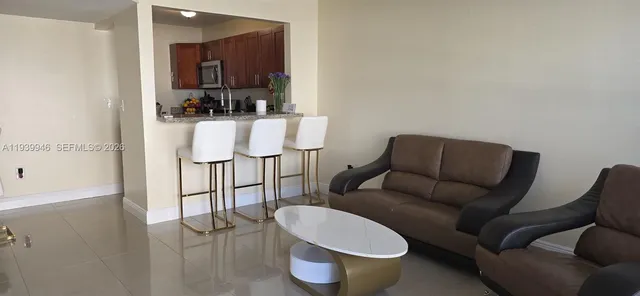 a living room with furniture a rug and a painting