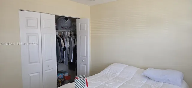 a bedroom with a bed and a closet