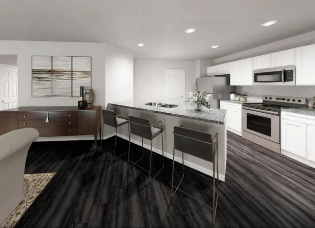 a large kitchen with stainless steel appliances granite countertop a stove and a sink