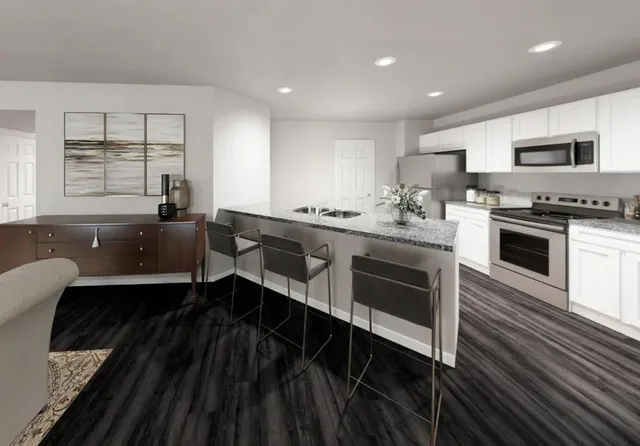 a kitchen with stainless steel appliances a stove sink and microwave