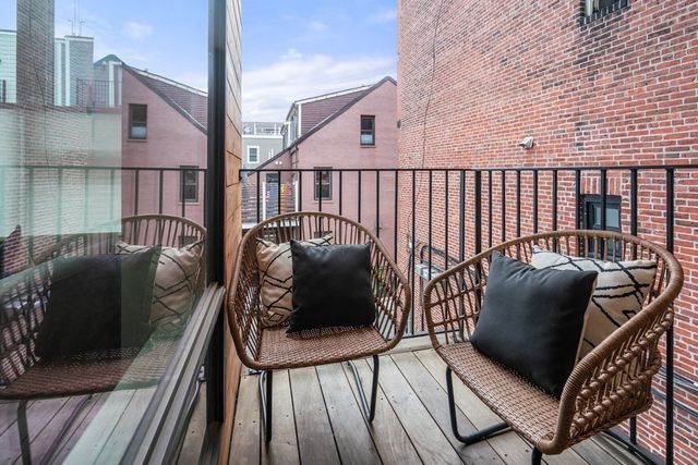 a view of a balcony with furniture