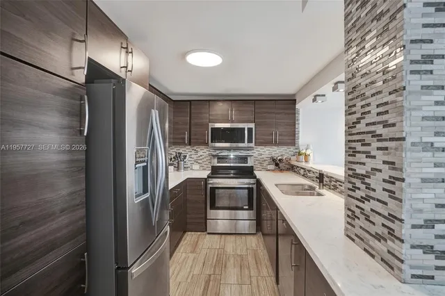 a kitchen with a sink stove and refrigerator