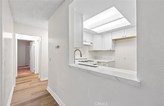 a kitchen with a sink a stove and cabinets
