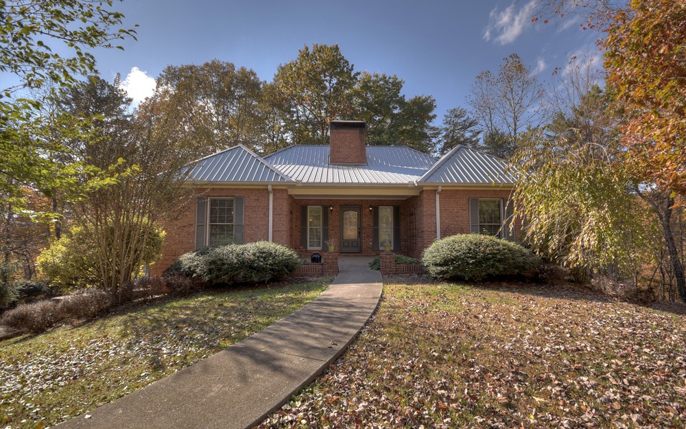 1328 Lucius Road Cherry Log, GA 30522 - Photo 1 of 1 a front view of a house with a yard and parking space