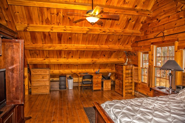 1403 Burt Hill Road Tolland, MA 01034 - Photo 18 of 30 a bedroom with a bed and a table with wooden floor