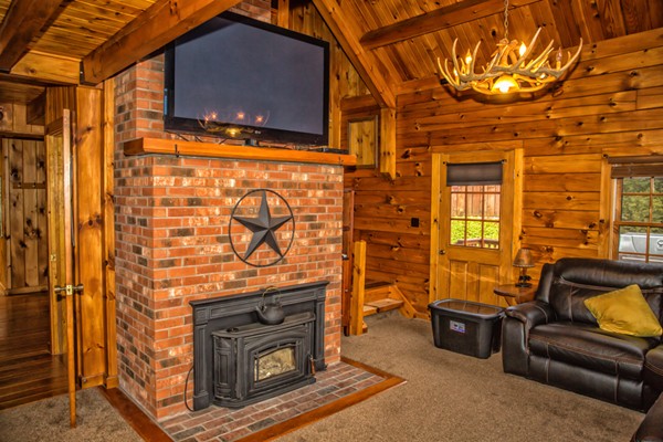 1403 Burt Hill Road Tolland, MA 01034 - Photo 7 of 30 a living room with furniture a flat screen tv and a fireplace
