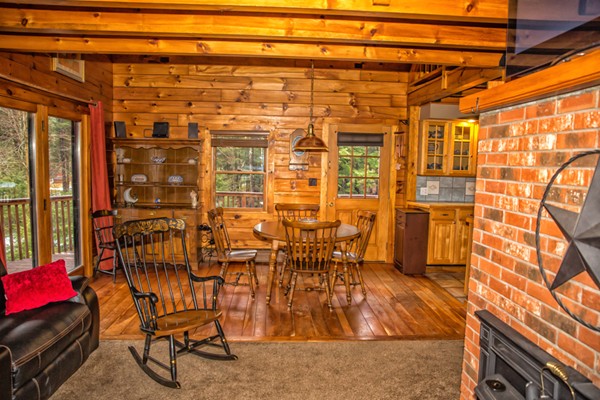 1403 Burt Hill Road Tolland, MA 01034 - Photo 8 of 30 a view of a porch with a table and chairs