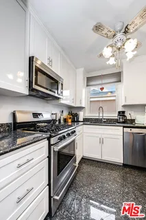 a kitchen with stainless steel appliances granite countertop a stove and a sink