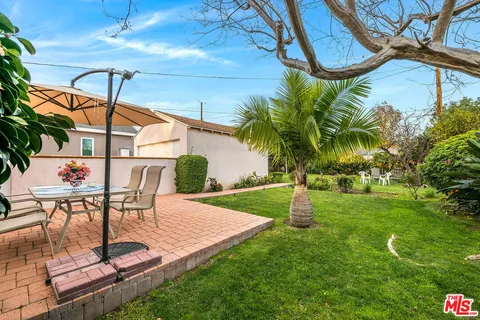 a view of a chairs and table in the patio
