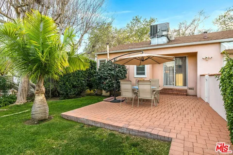 a white bench sitting in front of a house