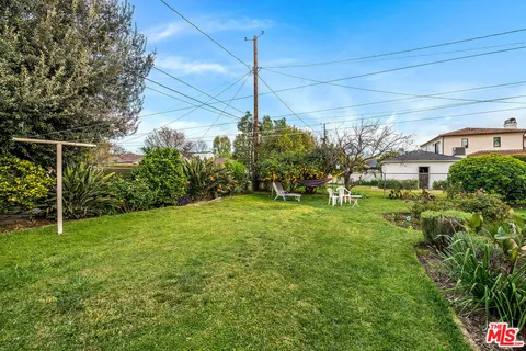 a yellow house with garden in front of it