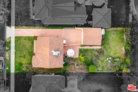 an aerial view of a house with a yard and garden