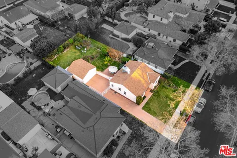 an aerial view of a house with a yard