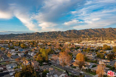 an aerial view of residential building with green space