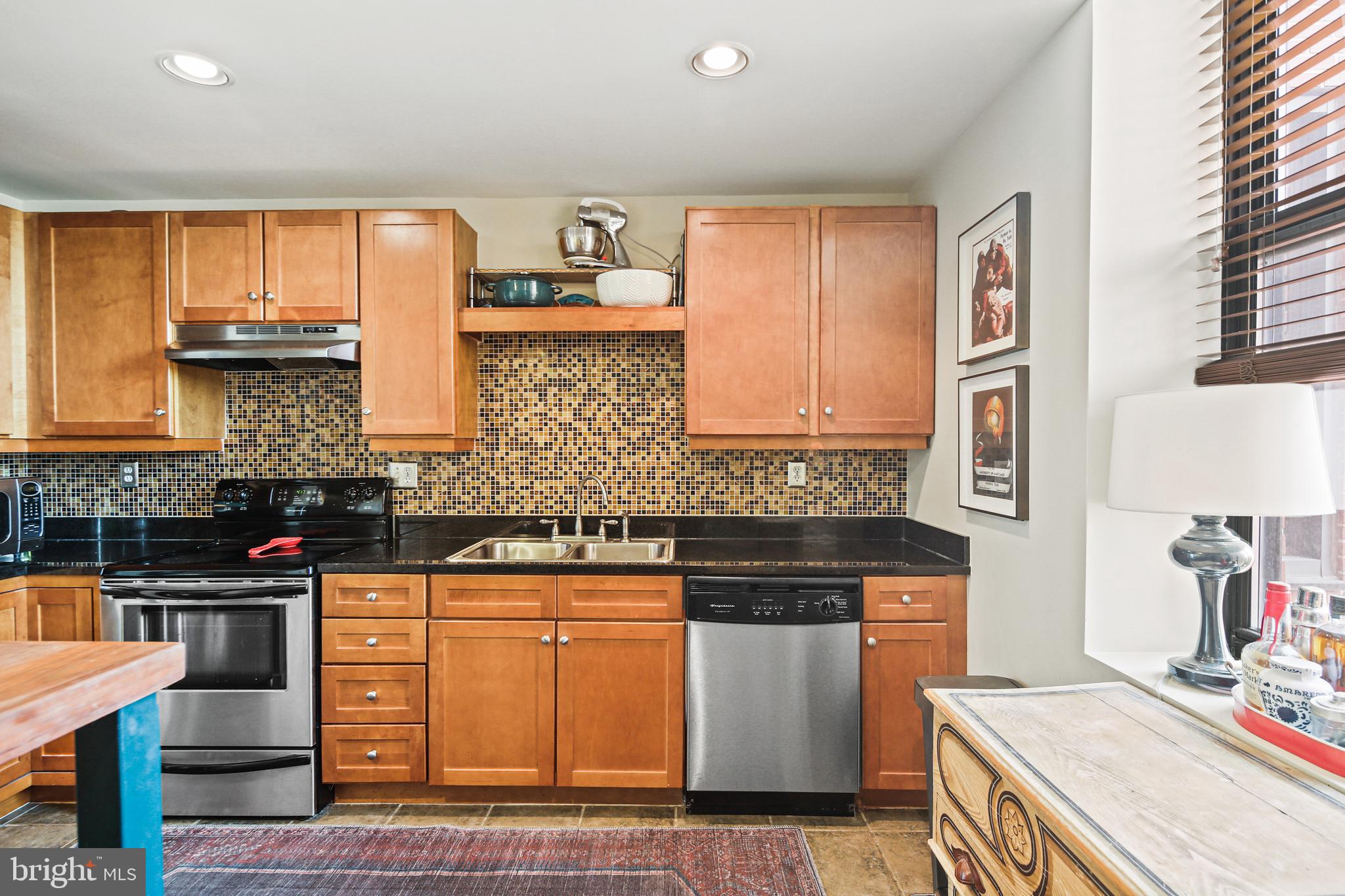 1211 Light Street, Unit 308 Baltimore, MD 21230 - Photo 12 of 29 a kitchen with stainless steel appliances granite countertop a stove a sink and a microwave