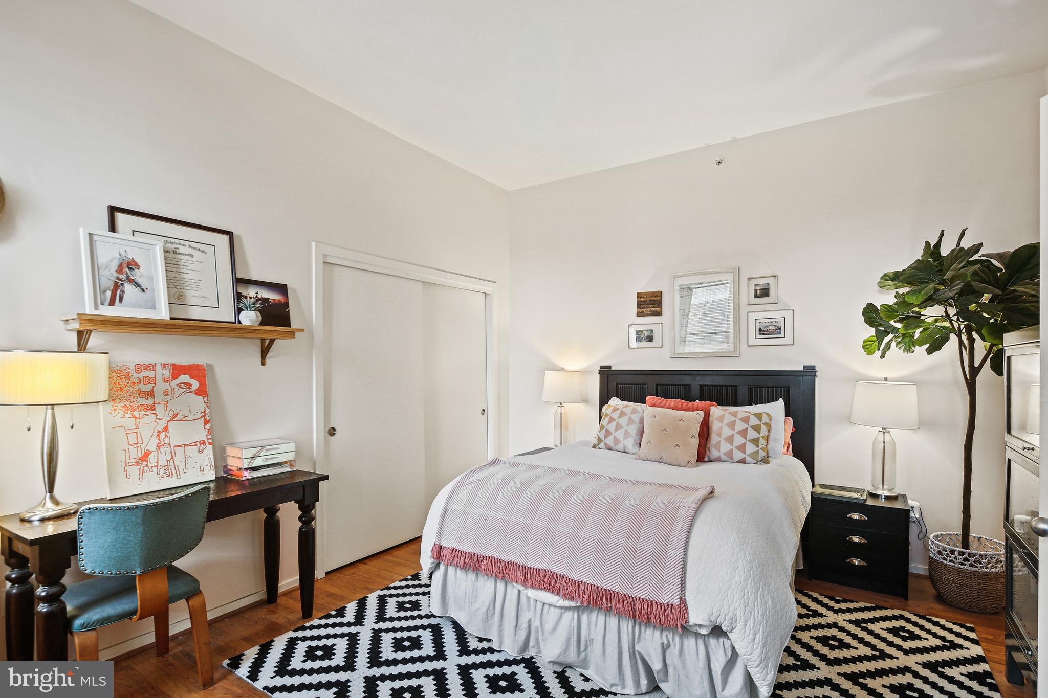 1211 Light Street, Unit 308 Baltimore, MD 21230 - Photo 4 of 29 a bedroom with a bed and wooden floor