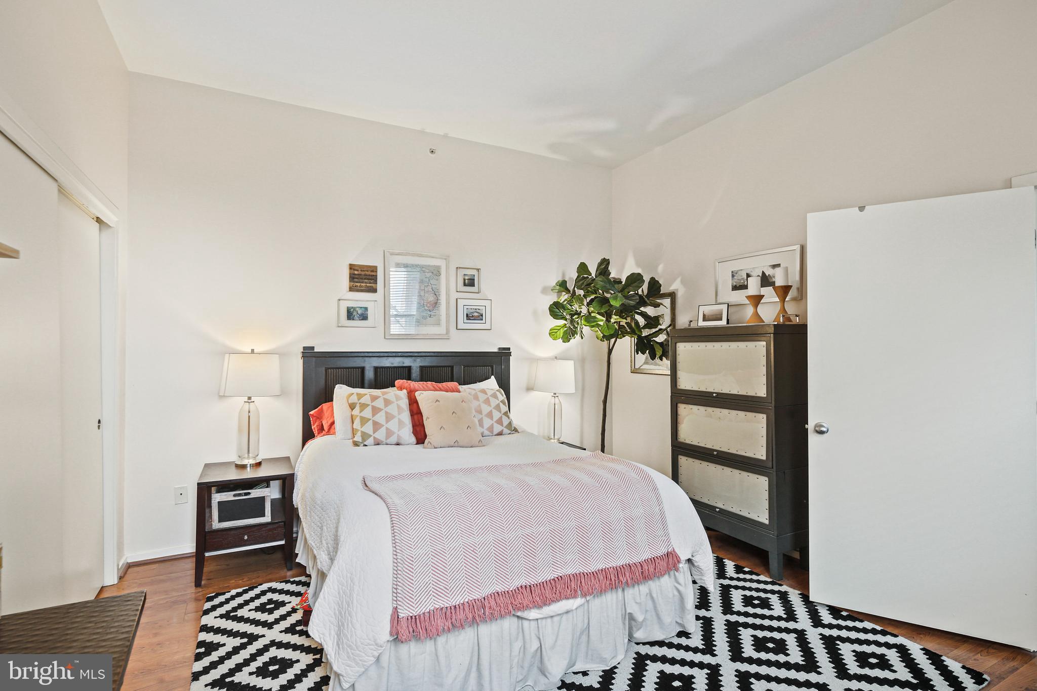 1211 Light Street, Unit 308 Baltimore, MD 21230 - Photo 5 of 29 a bedroom with a bed and a dresser