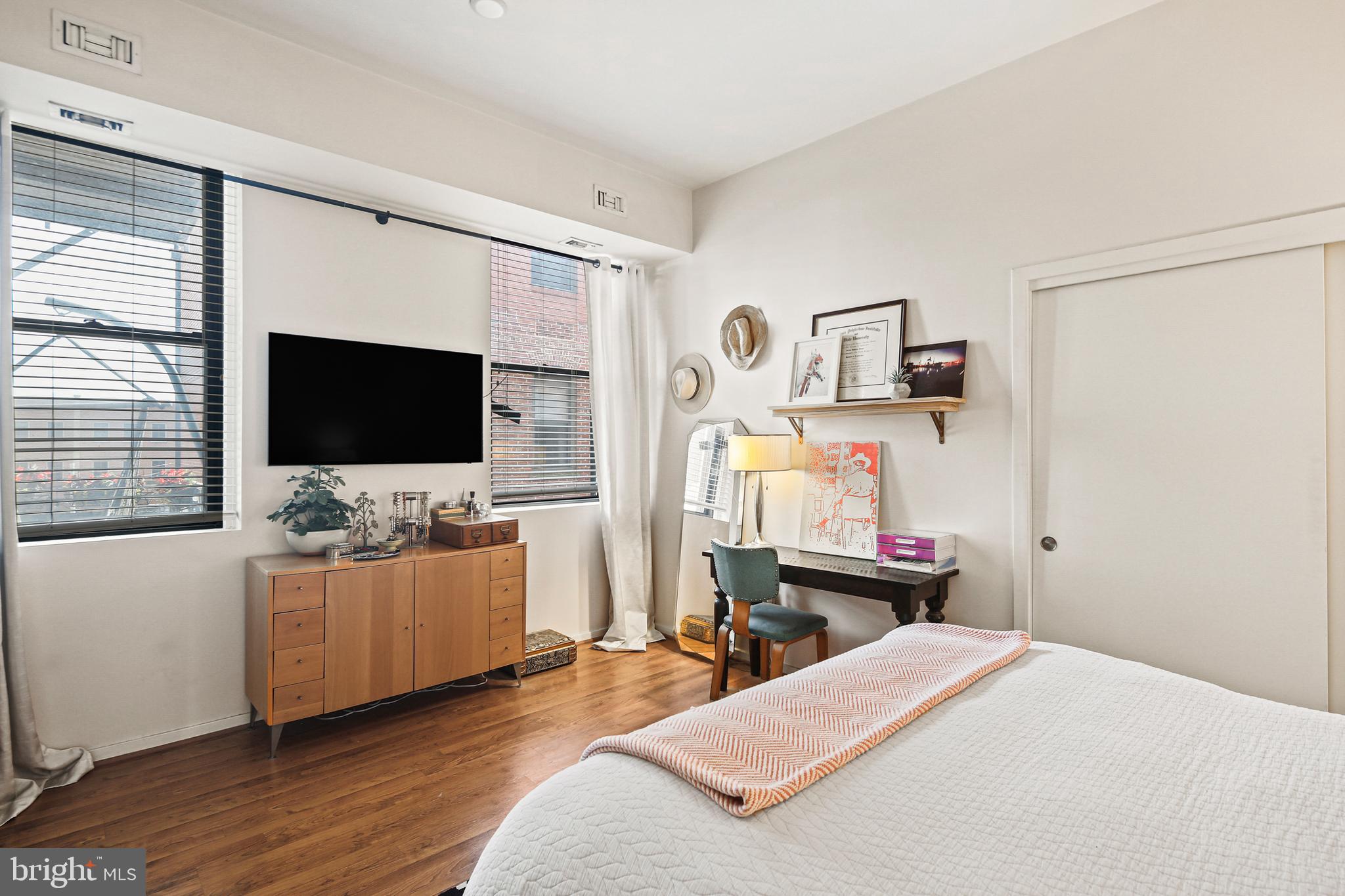 1211 Light Street, Unit 308 Baltimore, MD 21230 - Photo 6 of 29 a bedroom with a bed and a flat screen tv