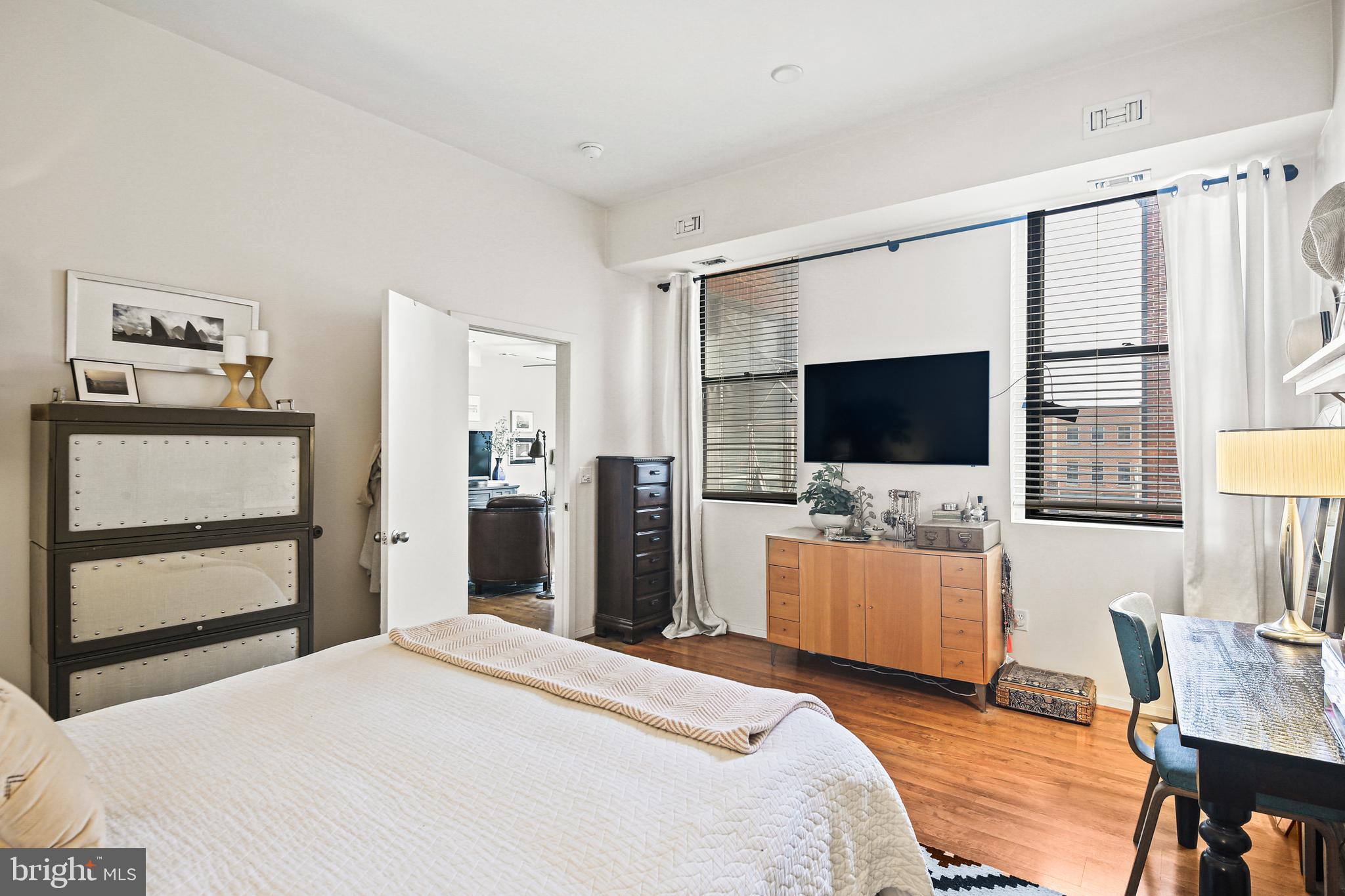 1211 Light Street, Unit 308 Baltimore, MD 21230 - Photo 7 of 29 a bedroom with a bed and a flat screen tv