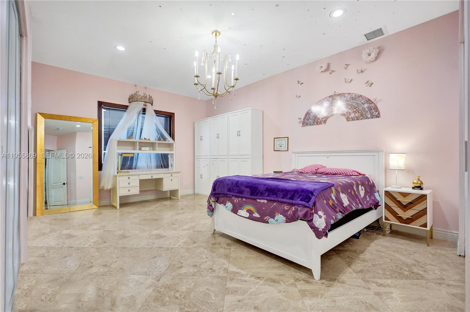 3175 Hunter Road Weston, FL 33331 - Photo 20 of 45 a spacious bedroom with a bed chandelier and a window