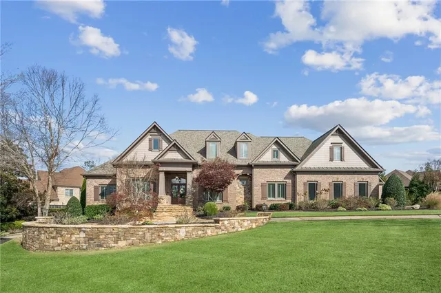 a front view of a house with a garden