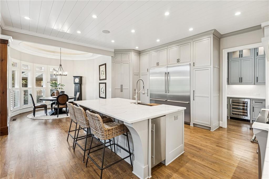 3030 Wills Mill Road Cumming, GA 30041 - Photo 3 of 71 a kitchen with stainless steel appliances a table chairs refrigerator and cabinets
