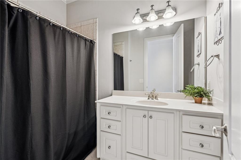 3030 Wills Mill Road Cumming, GA 30041 - Photo 37 of 71 a bathroom with a sink vanity and mirror