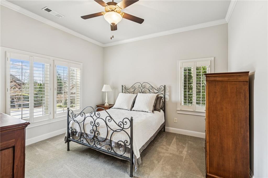 3030 Wills Mill Road Cumming, GA 30041 - Photo 38 of 71 a bed sitting in a bedroom next to a window