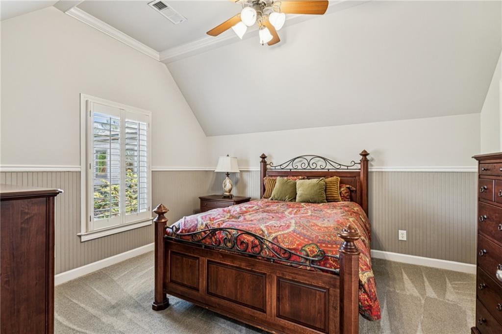 3030 Wills Mill Road Cumming, GA 30041 - Photo 48 of 71 a bedroom with a bed a chandelier and a window