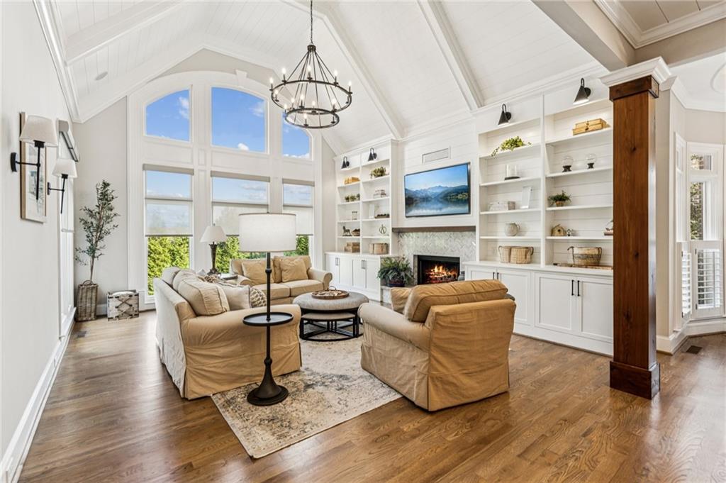 3030 Wills Mill Road Cumming, GA 30041 - Photo 5 of 71 a living room with furniture a fireplace and a chandelier