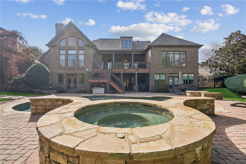 3030 Wills Mill Road Cumming, GA 30041 - Photo 62 of 71 a view of a house with swimming pool and a chairs in patio