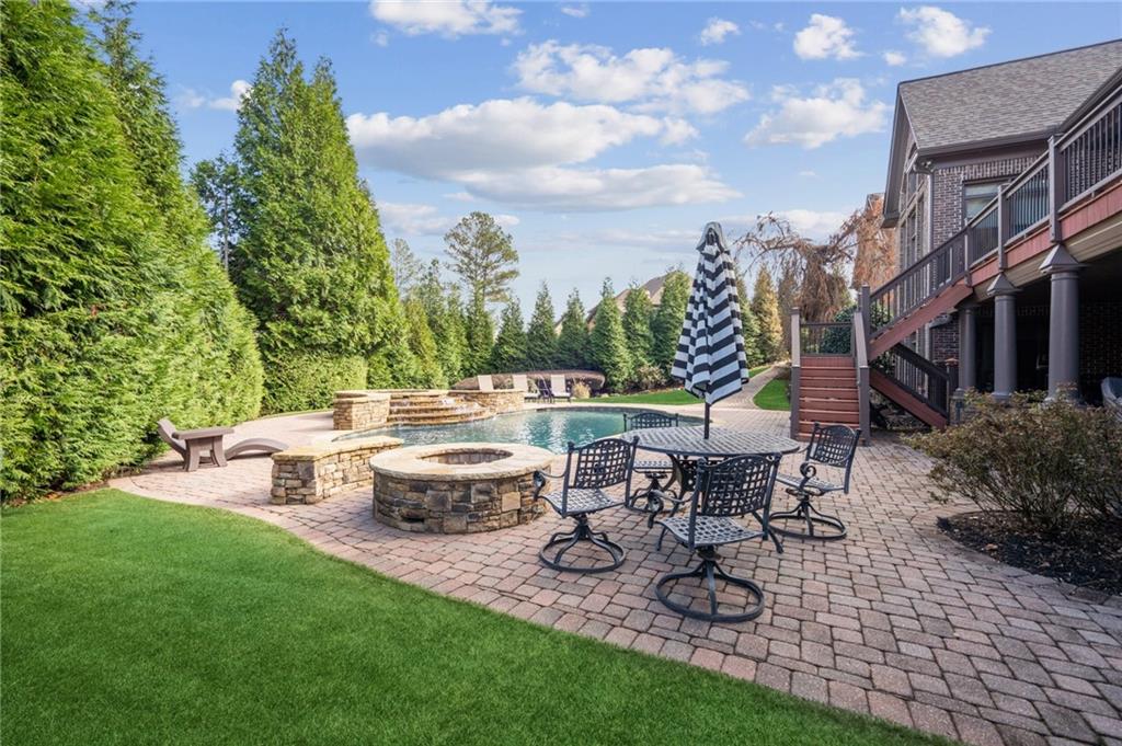 3030 Wills Mill Road Cumming, GA 30041 - Photo 9 of 71 a view of a patio with couches table and chairs and potted plants