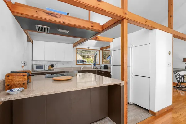 a kitchen with a sink appliances and cabinets