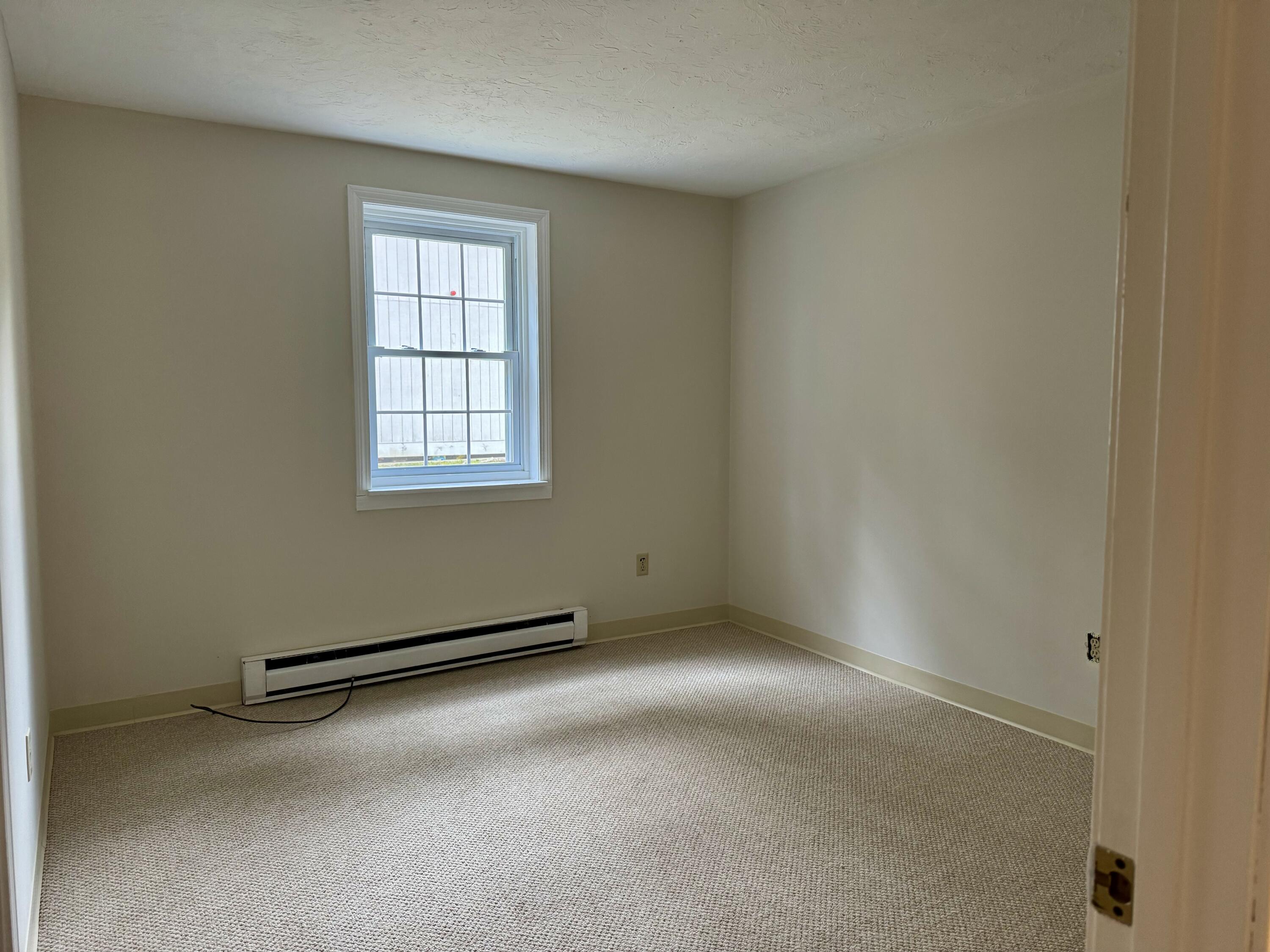70 Cape Drive, Unit 1B Mashpee, MA 02649 - Photo 11 of 13 an empty room with windows