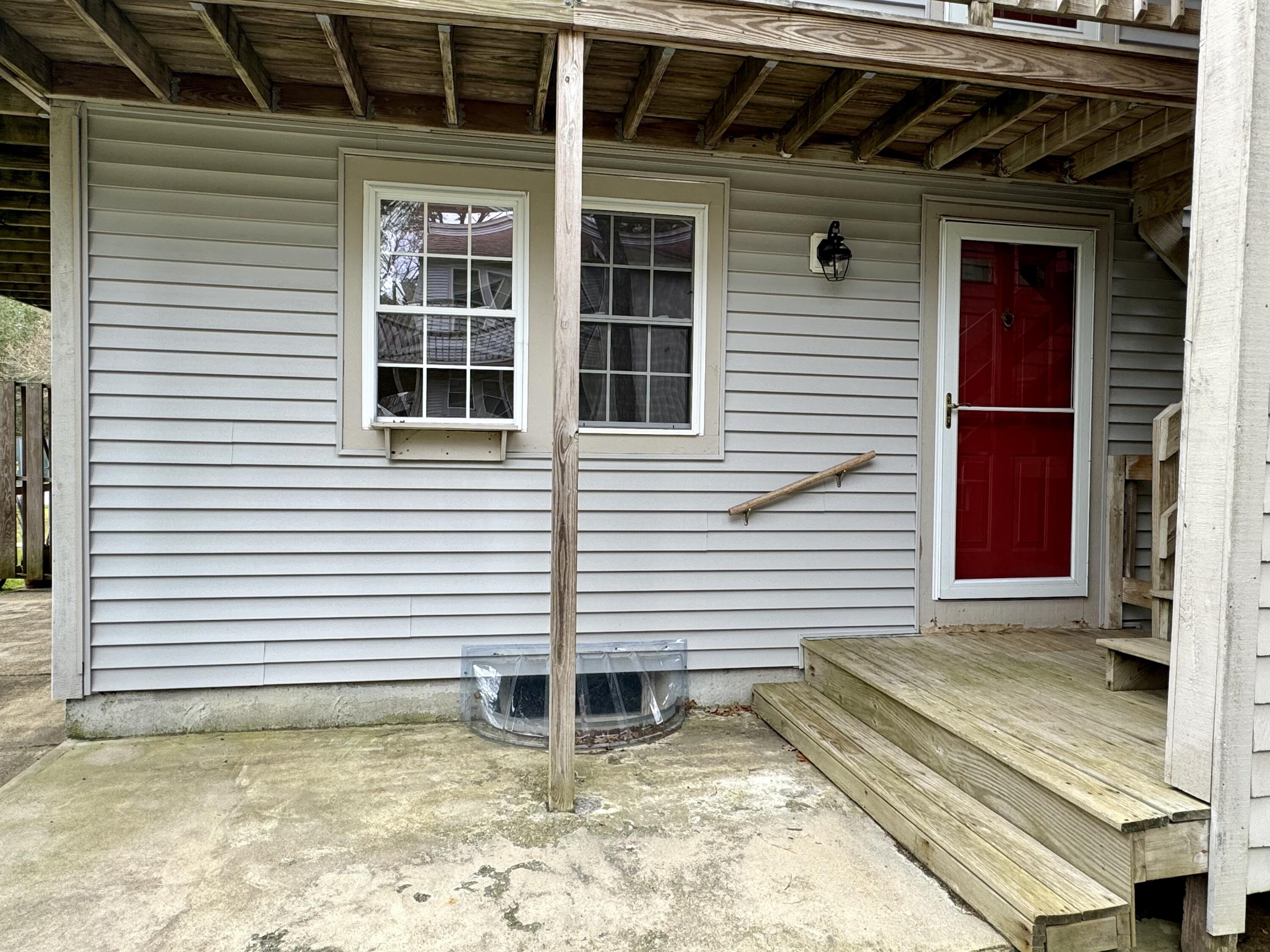 70 Cape Drive, Unit 1B Mashpee, MA 02649 - Photo 3 of 13 a view of a house with a door and wooden floor
