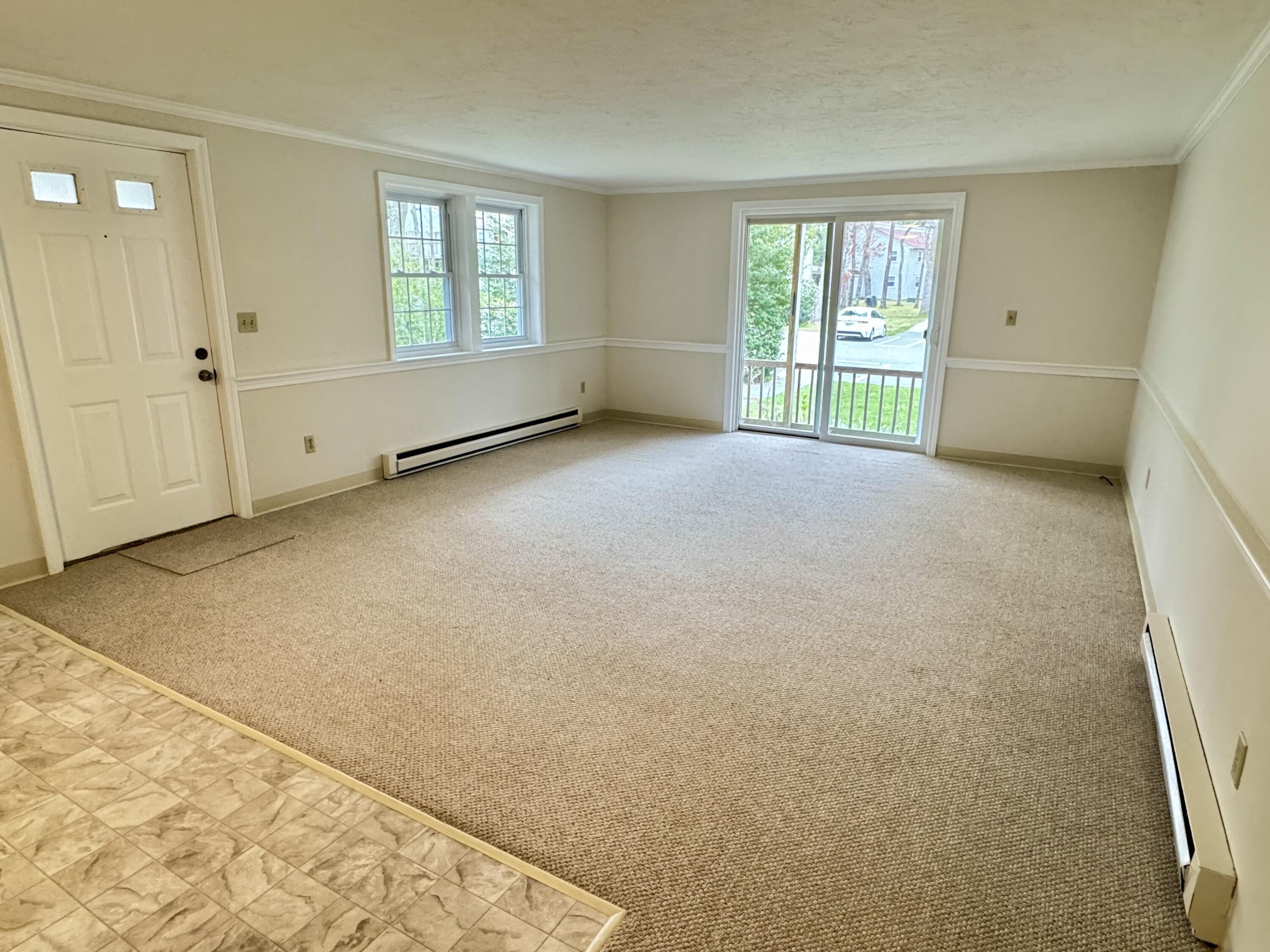 70 Cape Drive, Unit 1B Mashpee, MA 02649 - Photo 5 of 13 an empty room with windows