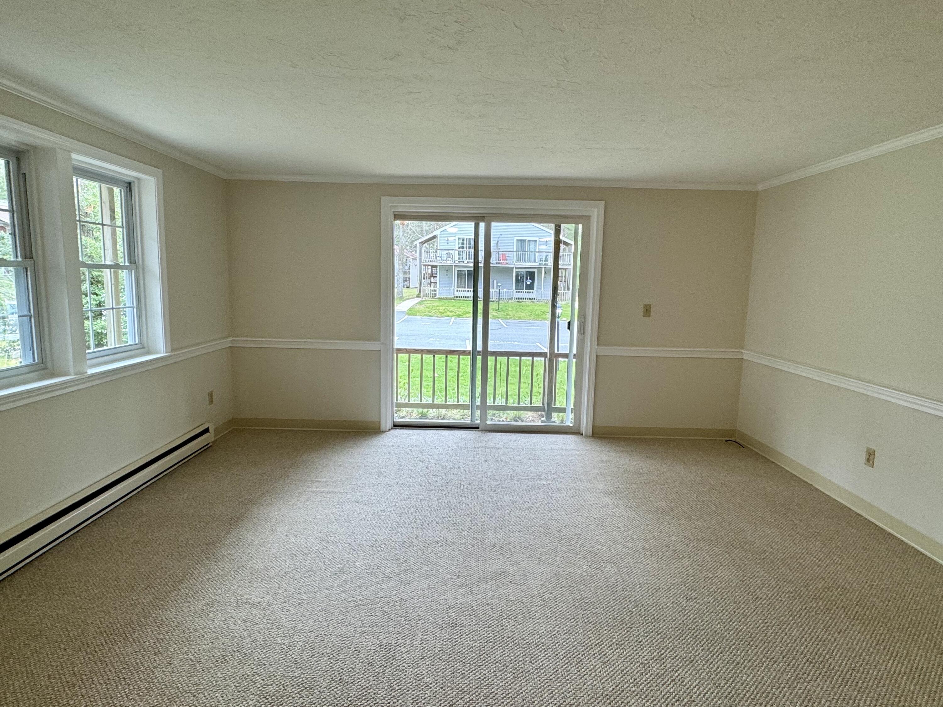 70 Cape Drive, Unit 1B Mashpee, MA 02649 - Photo 6 of 13 an empty room with windows