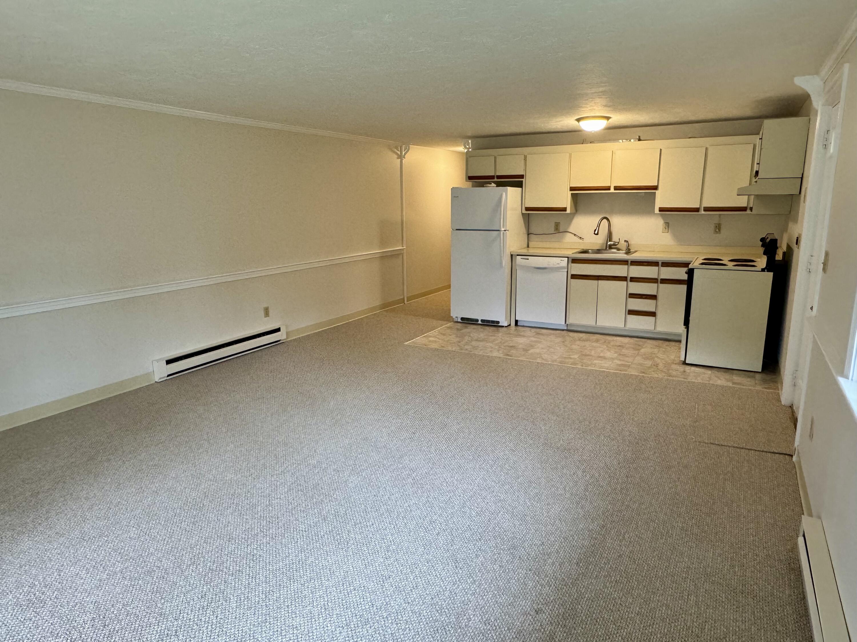 70 Cape Drive, Unit 1B Mashpee, MA 02649 - Photo 7 of 13 a kitchen with refrigerator and cabinets