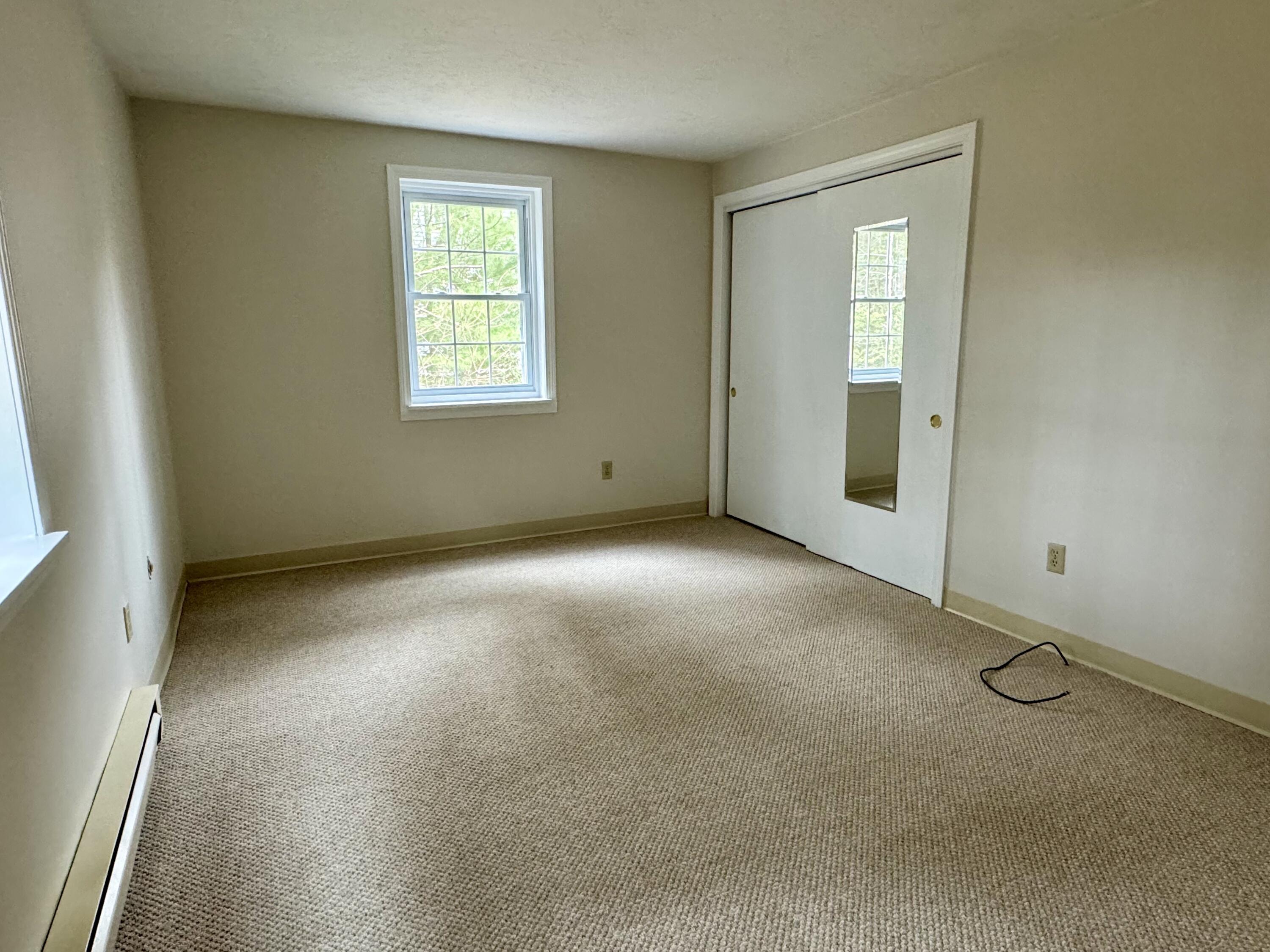 70 Cape Drive, Unit 1B Mashpee, MA 02649 - Photo 10 of 13 an empty room with windows