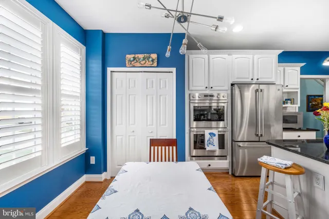 a kitchen with stainless steel appliances granite countertop a refrigerator microwave and stove