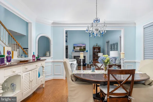 a view of a dining room with furniture and a chandelier