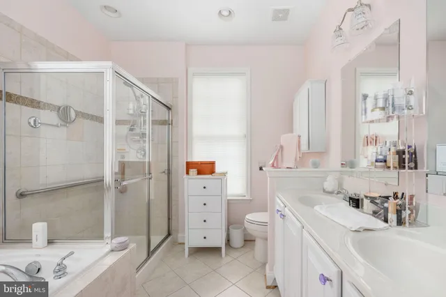a bathroom with a sink toilet tub and shower