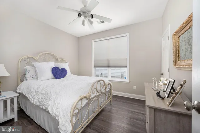 a bedroom with a bed and windows