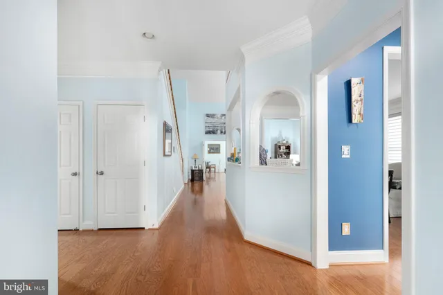 a view of a hallway with wooden floor and windows